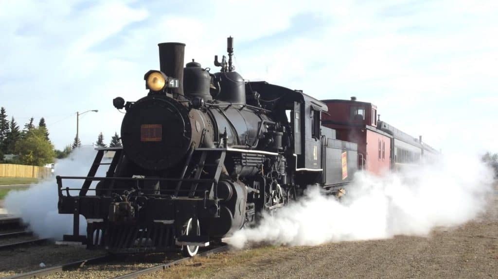 Steam train surrounded by white steam