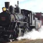 Steam train surrounded by white steam